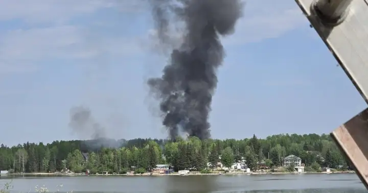 Wildfire west of Barrhead sets buildings on fire, residents ordered to evacuate – Edmonton